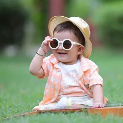 A stylish little boy enjoying a sunny day in the park. We use natural light to create warm, vibrant portraits that are full of life.