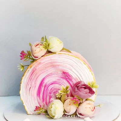 An elegant top-forward cake with a beautiful pink swirl texture. This modern design was for a mom's birthday and featured a new Rose Litchi flavor.