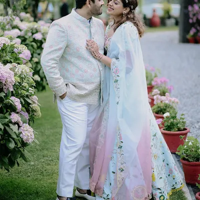 A beautiful portrait from a destination engagement in Nainital. The couple is surrounded by a garden of pastel flowers that perfectly complements their elegant outfits.