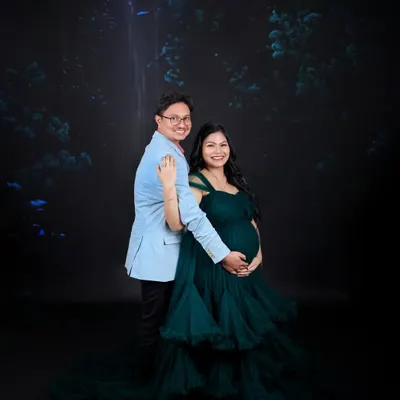 A couple's portrait showcasing our elegant dark green ruffled gown. The deep color provides a rich, luxurious feel, perfect for a dramatic and timeless look.