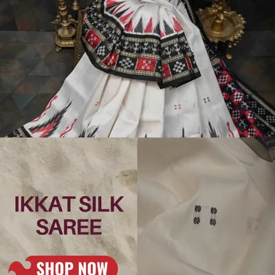 A classic Pochampally Ikkat silk saree in white, red, and black. The sharp, geometric patterns on the border and pallu are a hallmark of this incredible weaving technique.