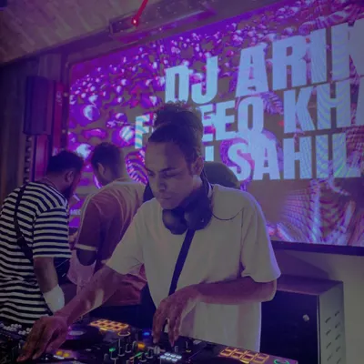 DJing under the purple lights of a packed club. I adapt my set to the venue, whether it's a high-energy nightclub or a chill lounge.