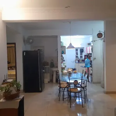 **BEFORE:** This living and dining area felt disconnected and cluttered, with structural elements breaking the flow. The space lacked a clear identity and was not optimized for family interaction.