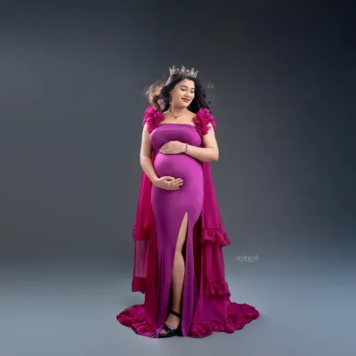 Feel regal in a bold magenta gown with a dramatic cape. I style these shots with accessories like a crown to complete the royal look, ensuring you feel confident and beautiful.