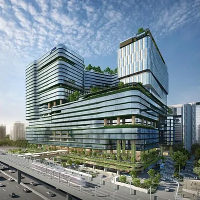A wide-angle rendering of the NESCO Centre Building II, showcasing its layered, green-terraced facade and its integration with public plazas and transportation infrastructure. This is a vision for a future-forward urban ecosystem.
