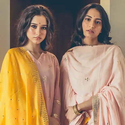 A group shot for a festive collection, showcasing two complementary looks. We used soft, glowing makeup and styled the models' hair with natural waves to create a cohesive and elegant image.
