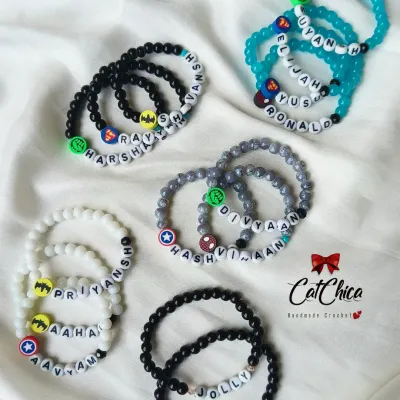 Our custom name bracelets for boys are always a hit! We use a variety of bead colors and fun charms like superheroes to match their style.