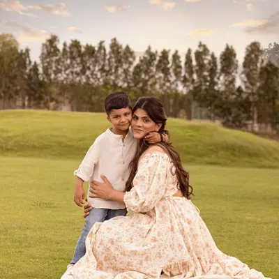 Every frame tells a story. This beautiful outdoor portrait of a mother and son, bathed in golden light, captures a moment of pure love and connection.