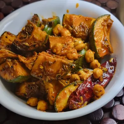 My special Aam Chana pickle, a true Punjabi classic. It has the perfect tangy kick from raw mangoes and a wonderful texture from the chickpeas, all mixed in pure mustard oil with my secret blend of spices.