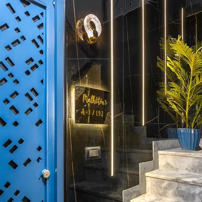 The entrance to your home should be bold and beautiful. For this project, I used a vibrant blue door with a custom laser-cut pattern, black marble walls, and dramatic linear lighting to create a stunning first impression.