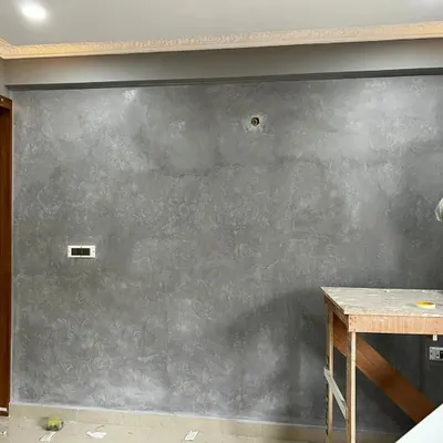 A sophisticated grey Marmorino texture finish, giving the wall a subtle, stone-like appearance that adds depth and an industrial-chic feel.