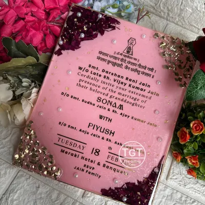 This 8x10 inch resin invitation was designed as the special first invite exchanged between families. It features preserved rose petals and stone work on the corners.