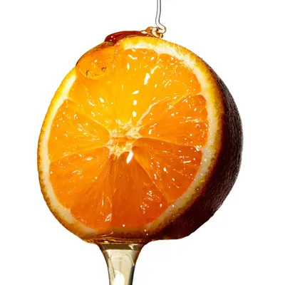 A personal project exploring texture and light. Here, a slice of orange is suspended with a drip of honey, backlit to make the fruit glow and highlight the viscosity of the liquid.
