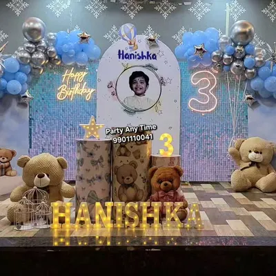 A complete teddy bear theme for a 3rd birthday. This setup includes a shimmer wall, moon prop, custom backdrop, themed plinths, and light-up letters.