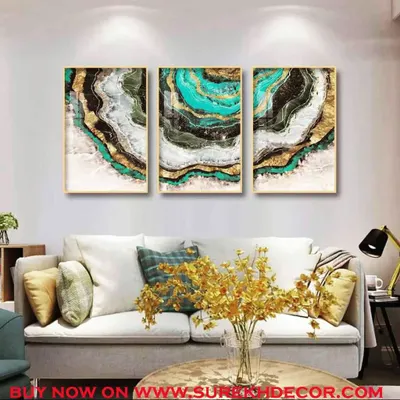 A triptych of crystal paintings that mimic the natural patterns of agate stone in vibrant teal, black, and gold. This set creates a powerful and luxurious statement above a sofa.