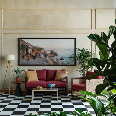 For the Primus Senior Living sales lounge, we designed this comfortable seating area featuring a custom red sofa and a cane armchair. The classic black and white checkered floor and large artwork create an eclectic, welcoming atmosphere.