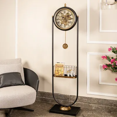 More than just a clock, this standing masterpiece blends industrial charm with practical elegance. It features a mesmerizing moving gear mechanism, a swinging pendulum, and a built-in shelf for displaying small decor items.