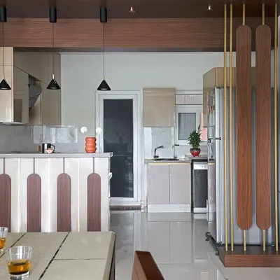 I reconfigured this kitchen in 'The Flux Abode' from a galley to an open U-shape. The design features a breakfast bar with unique paneling that separates it from the dining area while maintaining an open feel.