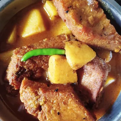 Dhokaar Dalna brings back so many memories of 'biyebari' (wedding) feasts from my childhood. These are savory lentil cakes, first fried and then simmered in a fragrant gravy with potatoes. It's my go-to dish for a hearty vegetarian meal.