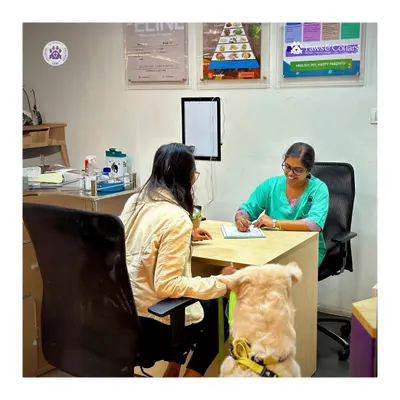Every consultation begins with listening. Here, a pet parent discusses their Golden Retriever's health with our veterinarian, who is taking detailed notes to create a personalized care plan. We partner with you to make informed decisions about your pet's nutrition, wellness, and treatment.