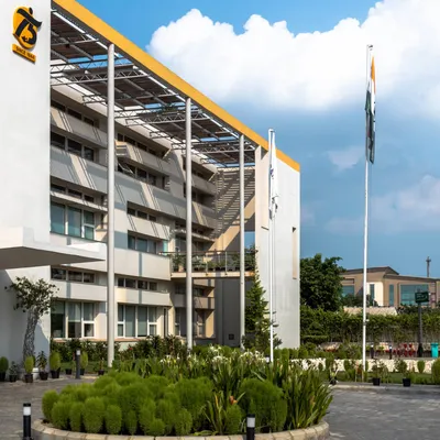 The exterior of a LEED Platinum certified office building I designed in Greater Noida. The design incorporates large overhangs and a prominent solar panel array on the roof, showcasing its sustainable credentials from the outside.