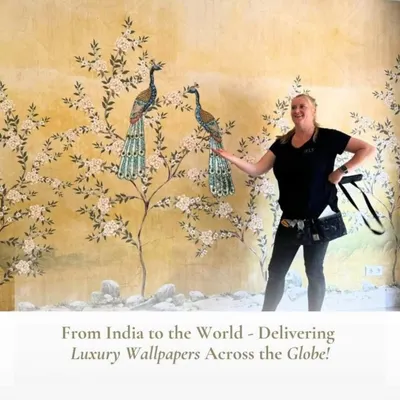 A client proudly showcasing her new wall featuring a stunning Chinoiserie-style mural with peacocks and blossoms. I can deliver these luxury, heritage-inspired designs to clients anywhere in the world.
