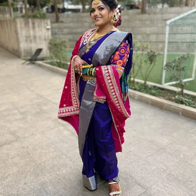 A full view of this stunning Marathi bride in her Nauvari saree. The draping is traditional and elegant, allowing her to move with confidence and grace.
