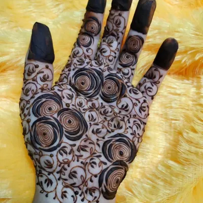 A unique and modern design featuring a net of spiraling roses. This is a fun twist on the classic 'jaal' pattern.