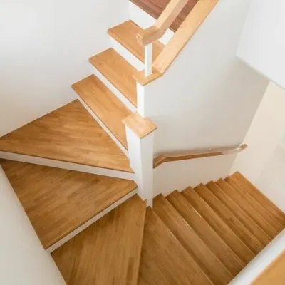 I don't just stop at flat surfaces. This winding staircase features custom-cut wooden treads that match the home's flooring. This creates a cohesive and elegant look that flows between levels.