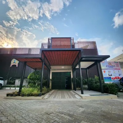 The redesigned entrance of a school, where we integrated a new covered walkway, a green courtyard, and a terracotta jaali screen. The design creates a welcoming and modern first impression that reflects the school's vision.