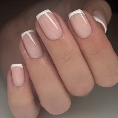 The quintessential classic French manicure. This look on short, square-shaped nails features a natural pink base and crisp white tips for a timelessly clean and elegant style.