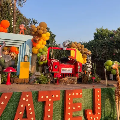 For this 'Wild Two' jungle themed birthday, we created a massive custom stage with marquee letters, a waterfall feature, and life-sized animal props to serve as the perfect backdrop for the celebration.