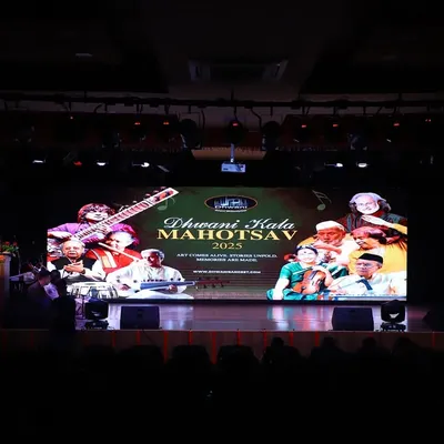 The stage is set for the Dhwani Kala Mahotsav 2025. A view from the audience, capturing the professional setup and anticipation before the show begins.