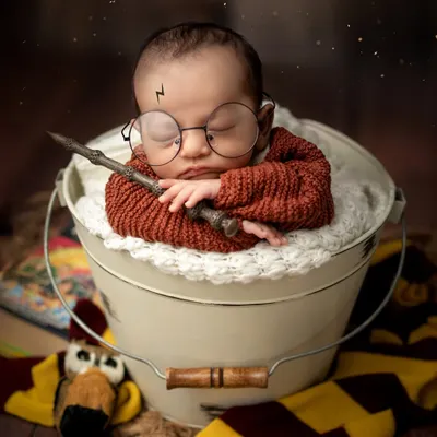 The boy who slept. This magical Harry Potter setup is complete with a wand, glasses, and a Gryffindor scarf, perfect for the newest fan in the family.