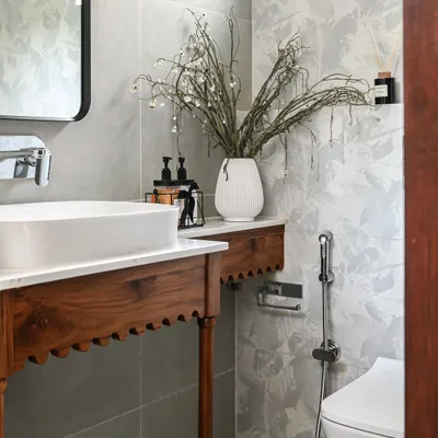 A close-up of the custom solid wood vanity in the Modern Spanish powder room. The arch details and spindle legs were thoughtfully designed to create an elegant and memorable feature, proving that even the smallest rooms can have a huge design impact.