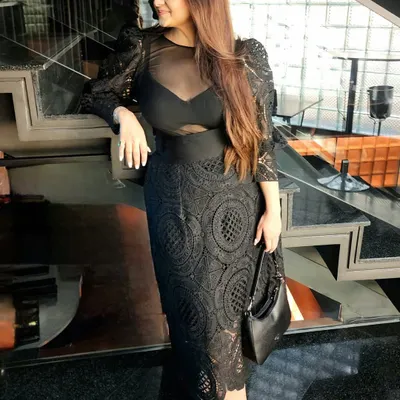A classic black dress is more than just fashion; it's a statement of presence and power. This look, featuring a lace dress with sheer details, shows how choosing black isn't about blending in, but about defining your space.