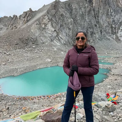 Standing before the stunning turquoise Gauri Kund lake during the Mount Kailash Parikrama. The raw beauty of the Himalayas is a powerful reminder of our own inner strength.