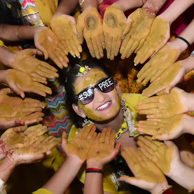 The quintessential Haldi shot! My makeup stays put even when the fun gets messy, ensuring the bride looks radiant and happy throughout.