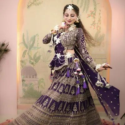 A full-length shot of our Radha-inspired look for Janmashtami, featuring a beautiful purple lehenga and delicate floral jewelry.