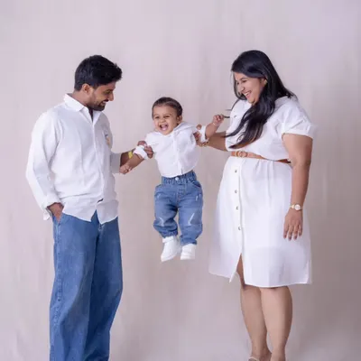 Sometimes the best shot is the one filled with action and laughter. This playful moment, with their toddler mid-air, is pure joy. It’s a perfect example of the fun, candid family photography we love to create.