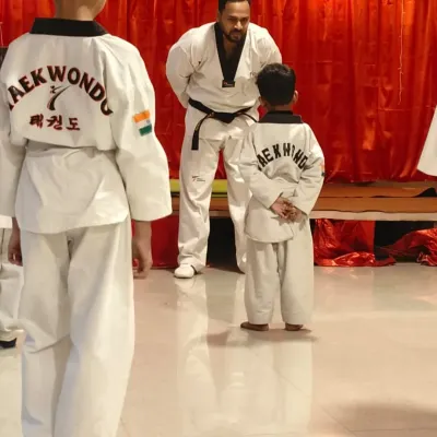 A moment of focus and respect during a belt promotion test. A student stands before the examiner, ready to demonstrate his skills.