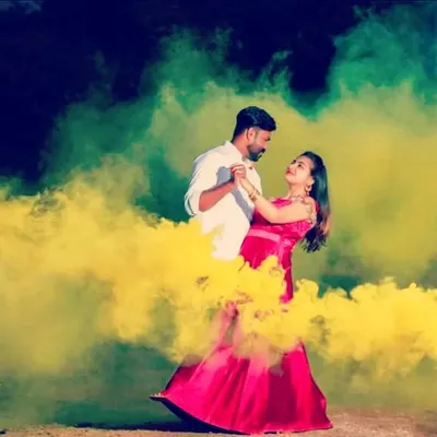 Using colored smoke bombs to create a vibrant and dreamy atmosphere for a couple's dance.