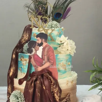 I had the honor of creating this divine Radha Krishna themed cake for an engagement. It features a beautiful illustration of the couple, peacock feathers, and a custom initial tag, all on a three-tier ganache cake.