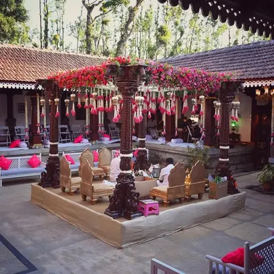 A full view of the ceremony setup within a 240-year-old Thottimane, where I used antique pillars for the mandap to complement the venue's historic architecture.