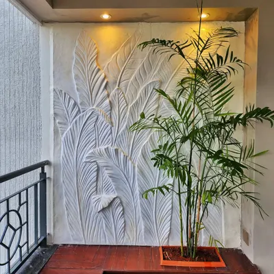 This 3D sculptural wall art was created for a residential balcony to add a touch of nature-inspired elegance. We used a fiber and plaster molding process to craft the overlapping tropical leaf design.