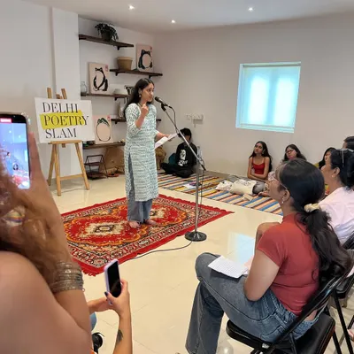A performer shares her piece at our studio open mic. The intimate setting, with the audience gathered close, is what makes these events feel like a true community gathering.