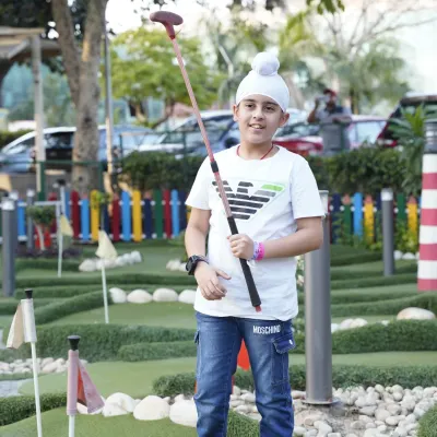 A moment of focus on our mini-golf course. It's a perfect activity for families to enjoy together, offering a calmer but equally engaging challenge.