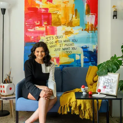 A portrait of me in my studio, a space where the lines between art and design blur. The large abstract painting behind me is a testament to the idea that it's okay to go after what you want.