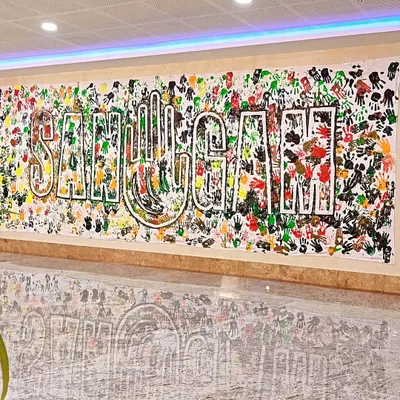 The final "SANGAM" handprint banner, created during a workshop with social workers and activists from across India. Each handprint represents an individual coming together to form a collective whole.