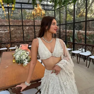 An ethereal white lehenga perfect for a daytime wedding or elegant reception. I styled this with delicate pearl and diamond jewelry to enhance its sophisticated, angelic feel.